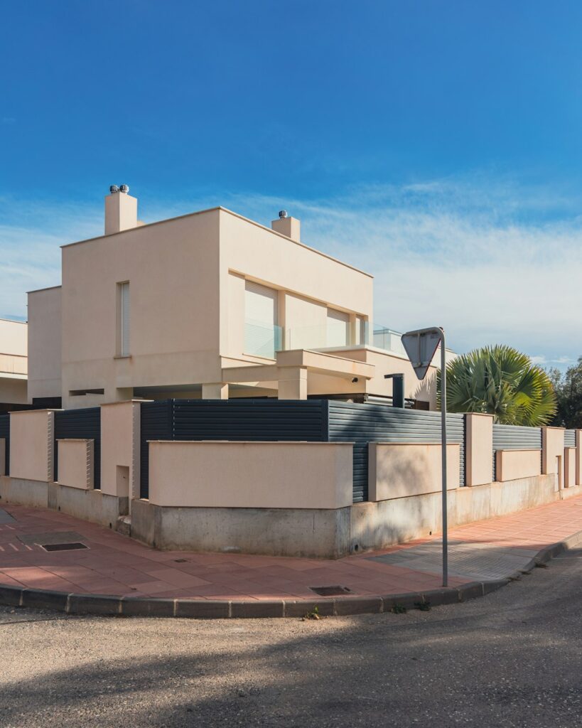 a-large-white-building-sitting-on-the-side-of-a-road-x8hwr8g8fty