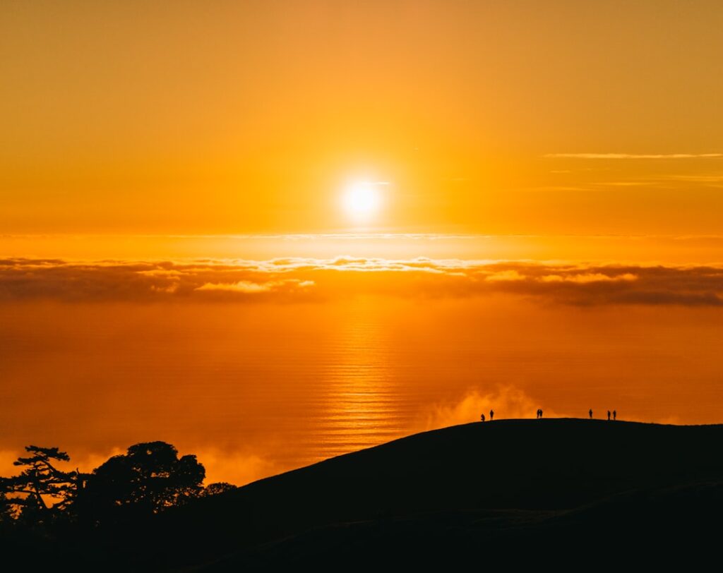 Orange sunrise and mountain silhouette