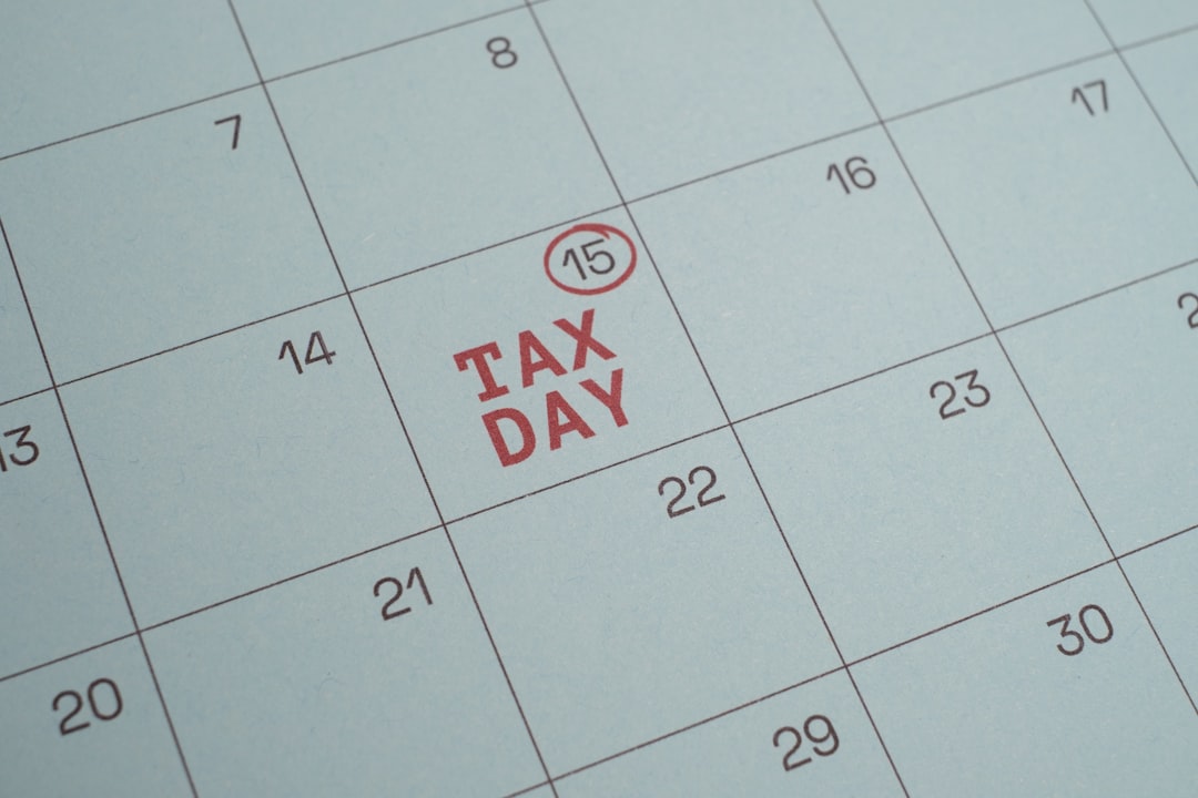 Tax Day. Blue Wall Calendar with April 15 Circled and Labeled as Tax Day Deadline. Close-up